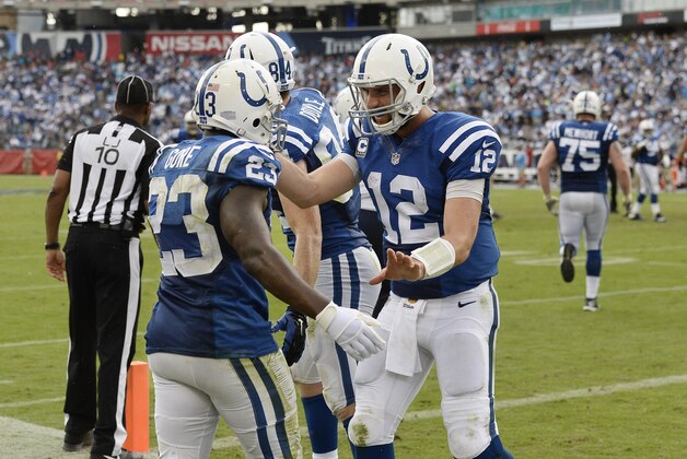 Indianapolis Colts running back Frank Gore (23) is congratulated by quarterback Andrew Luck (12) after Gore scored a touchdown on a 6-yard run against the Tennessee Titans in the second half of an NFL football game Sunday, Sept. 27, 2015, in Nashville, Tenn. (AP Photo/James Kenney)