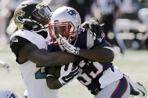 Jacksonville Jaguars outside linebacker Telvin Smith (50) tackles New England Patriots running back Dion Lewis in the first half of an NFL football game, Sunday, Sept. 27, 2015, in Foxborough, Mass. (AP Photo/Charles Krupa)