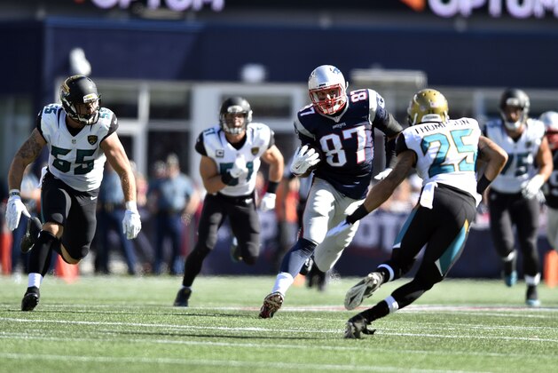 Sep 27, 2015; Foxborough, MA, USA; New England Patriots tight end Rob Gronkowski (87) carries the ball after a catch as Jacksonville Jaguars defensive back Peyton Thompson (25), outside linebacker Dan Skuta (55), and middle linebacker Paul Posluszny (51) defend in the third quarter at Gillette Stadium. New England defeated Jacksonville 51-17.  Mandatory Credit: James Lang-USA TODAY Sports