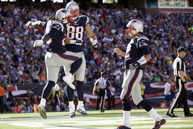 Sep 27, 2015; Foxborough, MA, USA; New England Patriots running back LeGarrette Blount (29) reacts with tight end Scott Chandler (88) and quarterback Tom Brady (12) after his touchdown against the Jacksonville Jaguars in the second half at Gillette Stadium. The Patriots defeated the the Jacksonville Jaguars 51-17. Mandatory Credit: David Butler II-USA TODAY Sports