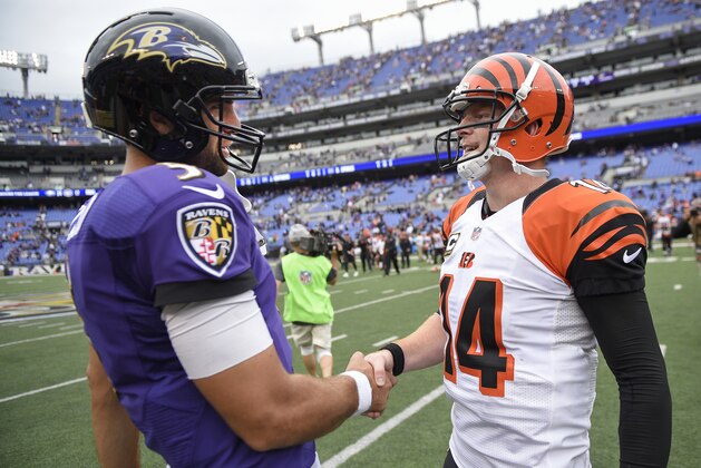 Cincinnati Bengals quarterback Andy Dalton (14) shakes hands with Baltimore Ravens quarterback Joe Flacco (5) after an NFL football game in Baltimore, Sunday, Sept. 27, 2015. The Bengals defeated the Ravens 28-24. (AP Photo/Nick Wass)