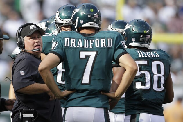 Philadelphia Eagles head coach Chip Kelly talks with Philadelphia Eagles quarterback Sam Bradford (7) during a time out against the New York Jets during the fourth quarter of an NFL football game, Sunday, Sept. 27, 2015, in East Rutherford, N.J. (AP Photo/Adam Hunger)
