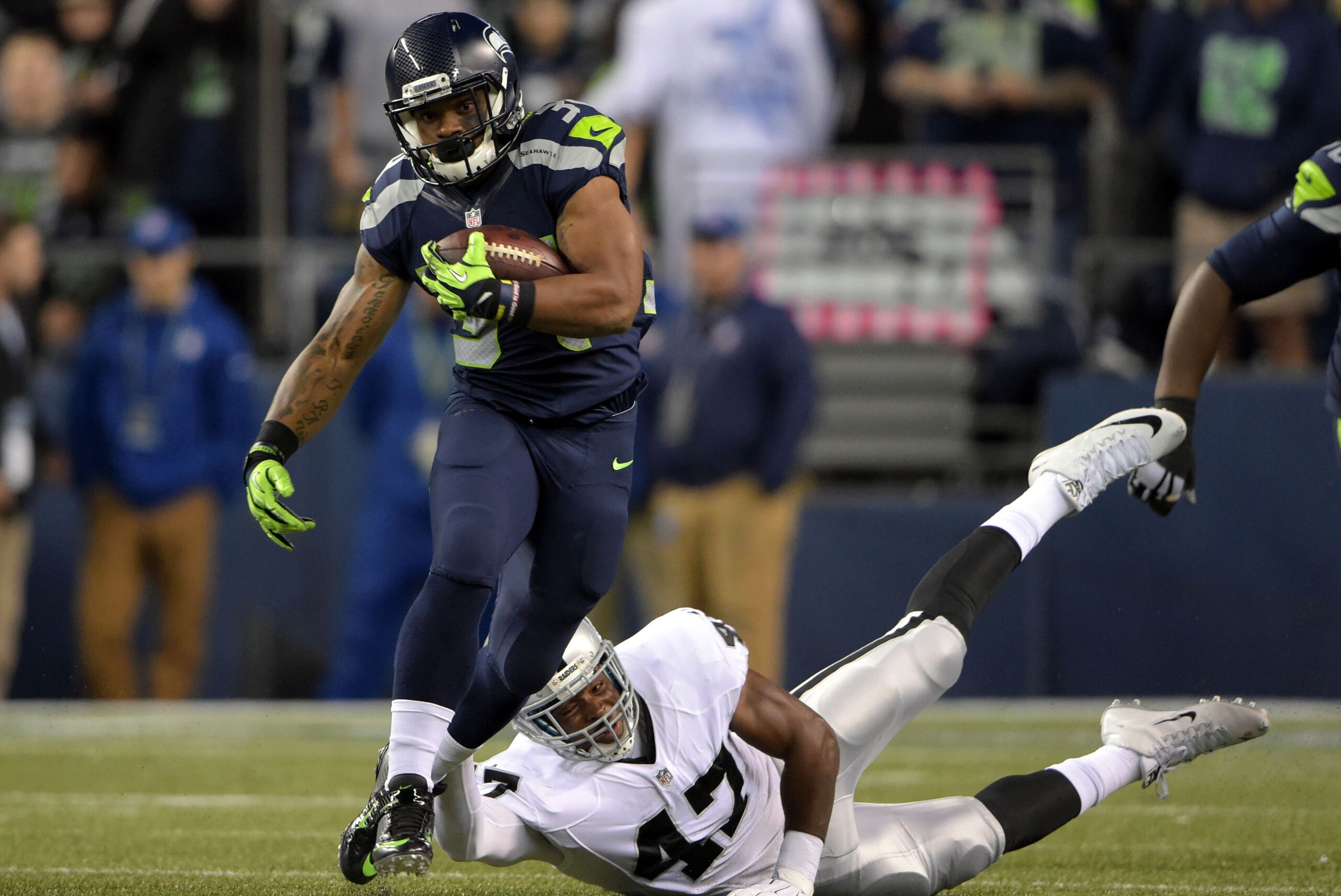Sep 3, 2015; Seattle, WA, USA; Seattle Seahawks running back Thomas Rawls (34) is defended by Oakland Raiders linebacker Josh Shirley (47) at CenturyLink Field. Mandatory Credit: Kirby Lee-USA TODAY Sports