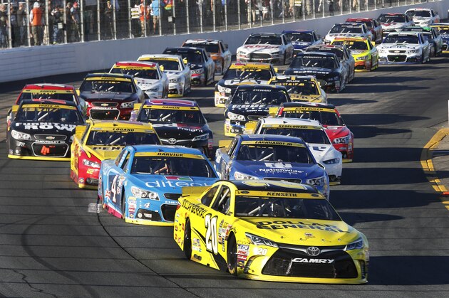 Matt Kenseth (20) takes the lead on a restart during the NASCAR Sprint Cup series auto race at New Hampshire Motor Speedway Sunday, Sept. 27, 2015, in Loudon, N.H. Kenseth won the race. (AP Photo/Jim Cole)