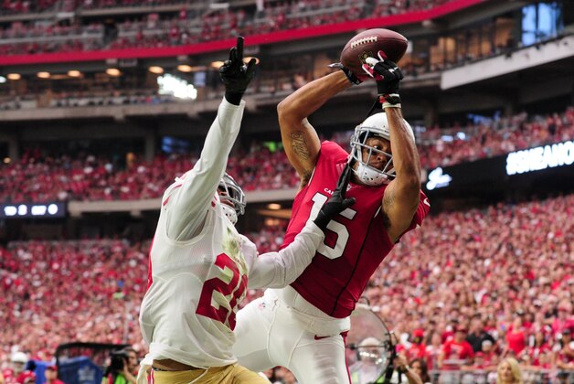 Sep 27, 2015; Glendale, AZ, USA; Arizona Cardinals wide receiver Michael Floyd (15) makes a catch as San Francisco 49ers cornerback Kenneth Acker (20) defends during the first half at University of Phoenix Stadium.  The play was later recalled for a penalty.  Mandatory Credit: Matt Kartozian-USA TODAY Sports