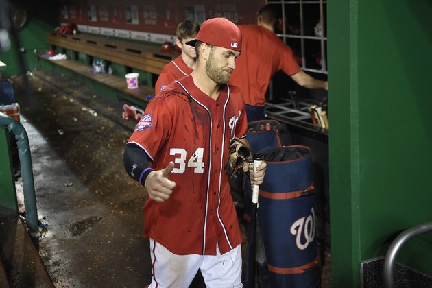 Washington Nationals' Bryce Harper (34) gestures and walks along the dugout after a baseball game against the Philadelphia Phillies, Saturday, Sept. 26, 2015, in Washington. Harper drove in the game-winning run as the Nationals won 2-1 in 12 innings. (AP Photo/Nick Wass)