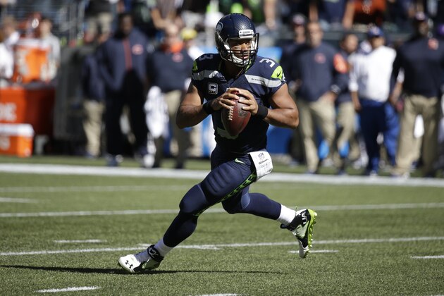 Seattle Seahawks quarterback Russell Wilson drops to pass against the Chicago Bears in the first half of an NFL football game, Sunday, Sept. 27, 2015, in Seattle. (AP Photo/Elaine Thompson)