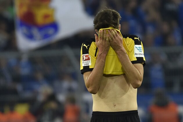Dortmund's Julian Weigl stands on the pitch disappointed after the German Bundesliga soccer match between Borussia Dortmund and SV Darmstadt in Dortmund, Germany, Sunday, Sept. 27, 2015. The match ended 2-2. (AP Photo/Martin Meissner)