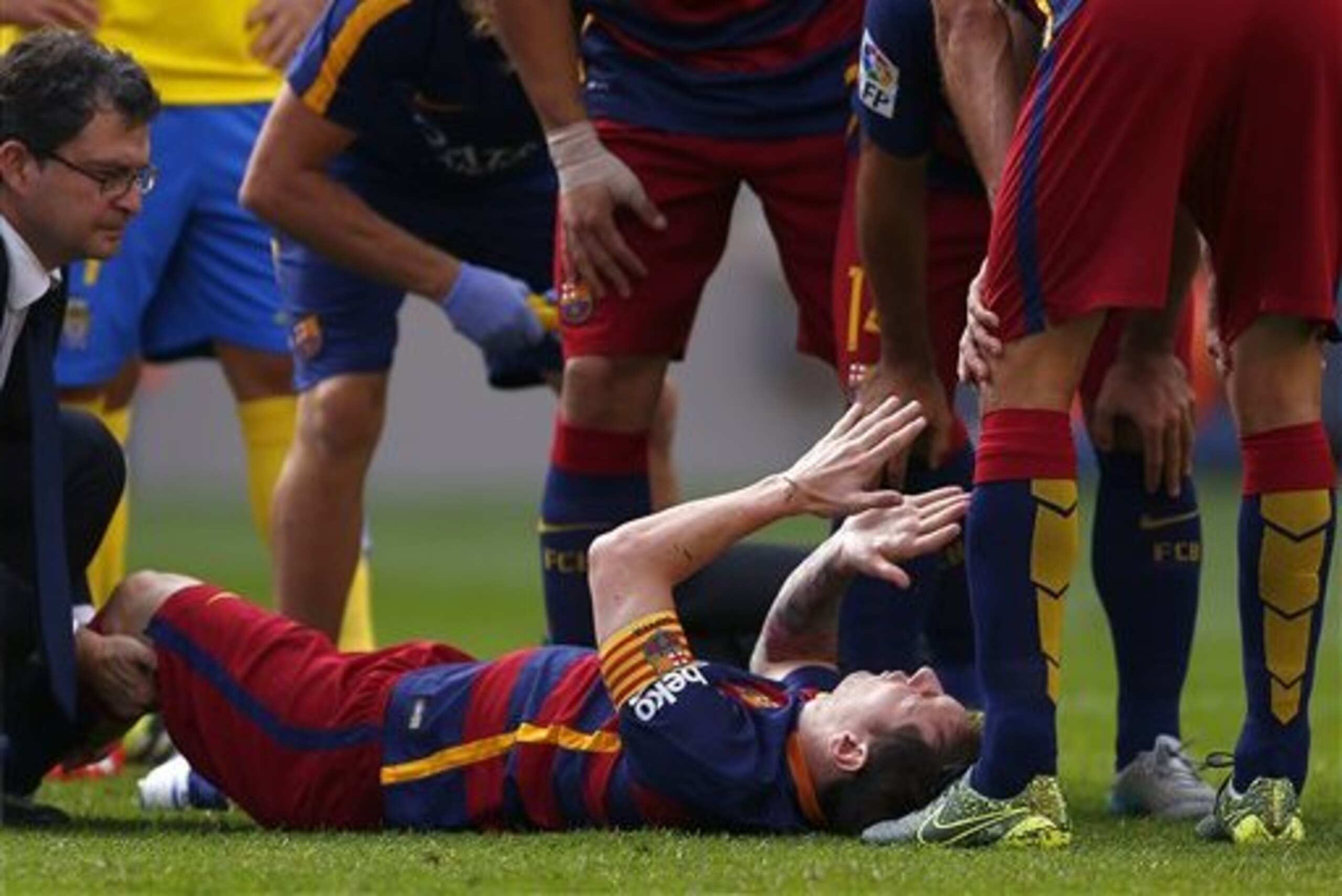 FC Barcelona's Lionel Messi, from Argentina, reacts after being injured,  during a Spanish La Liga soccer match against Las Palmas at the Camp Nou stadium in Barcelona, Spain, Saturday, Sept. 26, 2015. (AP Photo/Manu Fernandez)