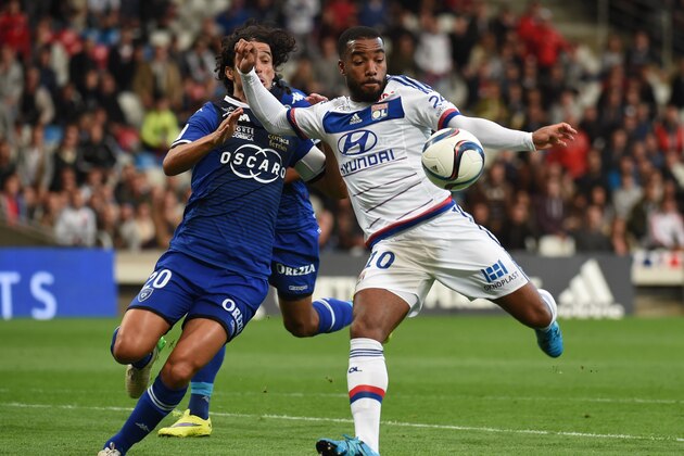 Lyon's French forward Alexandre Lacazette (R) vies with Bastia's French defender Francois Modesto (L) during the French L1 football match between Olympique Lyonnais against Sporting Club de Bastia on September 23, 2015 at the Gerland stadium in Lyon, Southeastern France.        AFP PHOTO / PHILIPPE DESMAZES        (Photo credit should read PHILIPPE DESMAZES/AFP/Getty Images)