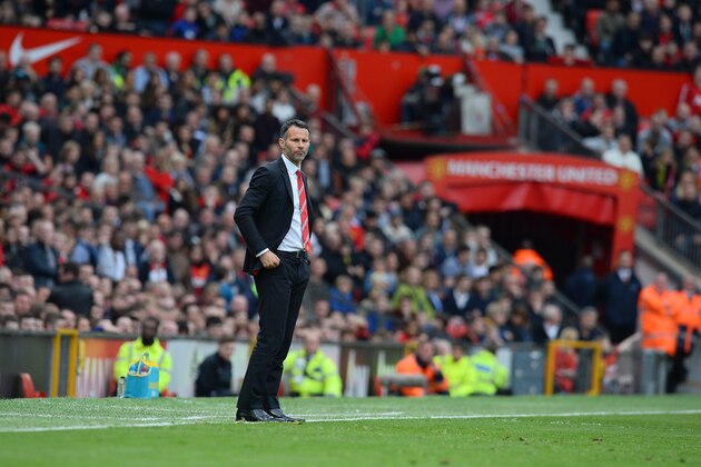 Manchester United's caretaker manager Ryan Giggs is pictured during the English Premier League football match between Manchester United and Norwich City at Old Trafford in Manchester, northwest England, on April 26, 2014. AFP PHOTO/ANDREW YATES
RESTRICTED TO EDITORIAL USE. NO USE WITH UNAUTHORIZED AUDIO, VIDEO, DATA, FIXTURE LISTS, CLUB/LEAGUE LOGOS OR LIVE SERVICES. ONLINE IN-MATCH USE LIMITED TO 45 IMAGES, NO VIDEO EMULATION. NO USE IN BETTING, GAMES OR SINGLE CLUB/LEAGUE/PLAYER PUBLICATIONS        (Photo credit should read ANDREW YATES/AFP/Getty Images)