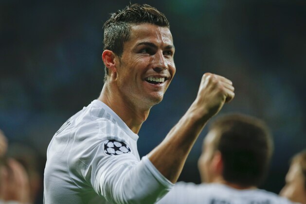 Real Madrid's Cristiano Ronaldo celebrates after scoring  after an hat trick during a Group A Champions League soccer match between Real Madrid and Shakhtar Donetsk at the Santiago Bernabeu stadium in Madrid, Spain, Tuesday, Sept. 15, 2015. (AP Photo/Paul White)