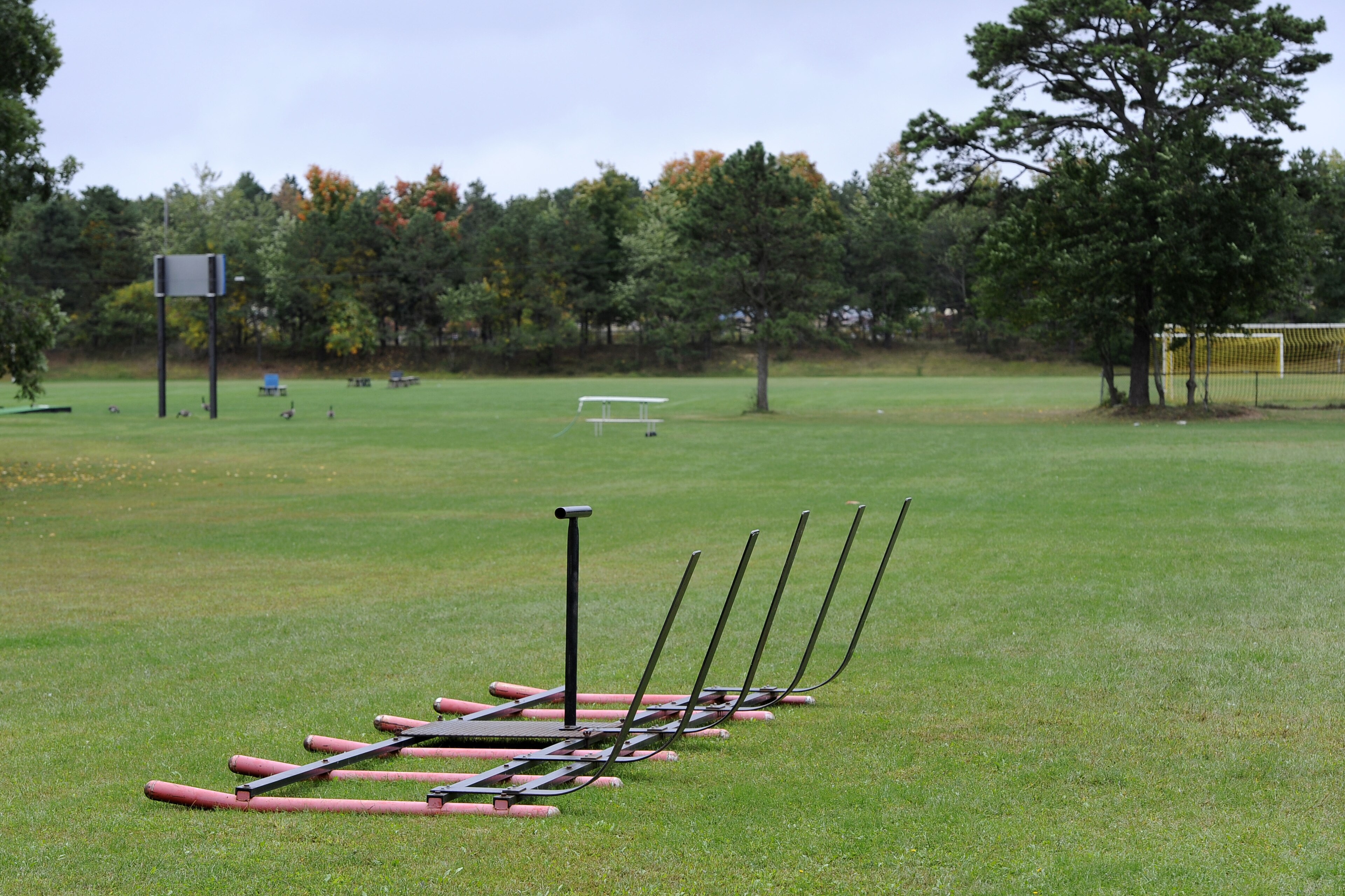 Equipment sits on a football practice field near the main entrance for Shoreham-Wading River High School, Thursday, Oct. 2, 2014, in Shoreham, N.Y. Authorities say Tom Cutinella, 16-year-old football player at the high school, died at a hospital the night before after suffering a head injury in an on-field collision during a game with John Glenn High School in Elwood, N.Y.  (AP Photo/Kathy Kmonicek)