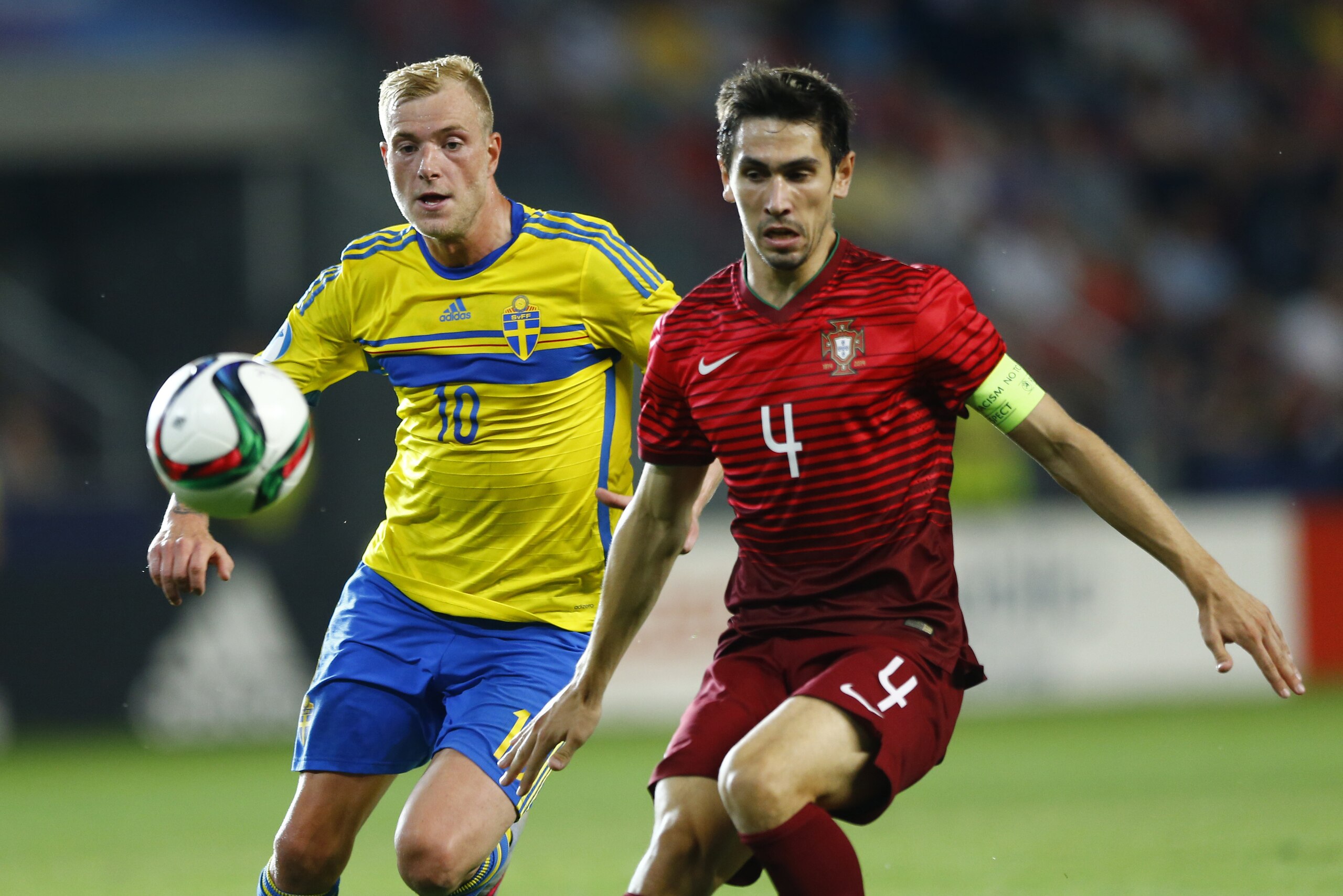 Sweden’s John Guidetti. left, and Portugal’s Paulo Oliveira challenge for the ball during the final match at the Euro U21 soccer championship between Sweden and Portugal at the Eden stadium in Prague, Czech Republic, Tuesday, June 30, 2015. (AP Photo/Matthias Schrader)