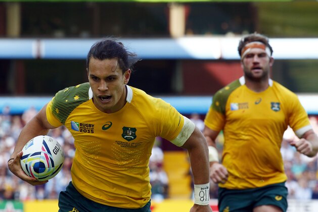Australia's Matt Toomua goes for the line to score a try during the Rugby World Cup Pool A match between Australia and Uruguay at Villa Park, Birmingham, England, Sunday, Sept. 27, 2015. (AP Photo/Martin Cleaver)