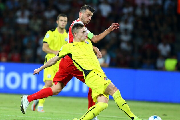 Albanian player Blendi Shkembi, left, of Skenderbeu fights for the ball with Croatia's Marko Rog of Dinamo Zagreb in the Champions League play off match held in Elbasan,Albania, Wednesday, Aug. 19, 2015. (AP Photo/Hektor Pustina)