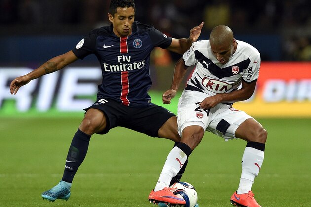 Paris Saint-Germain's Brazilian defender Marquinhos (L) challenges Bordeaux's Tunisian midfielder Wahbi Khazri during the French L1 football match between Paris Saint-Germain (PSG) and Bordeaux at the Parc des Princes stadium in Paris on September 11, 2015. AFP PHOTO / FRANCK FIFE        (Photo credit should read FRANCK FIFE/AFP/Getty Images)