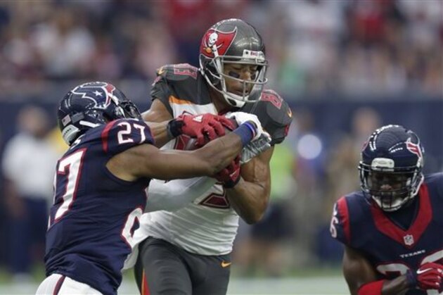 Tampa Bay Buccaneers' Vincent Jackson (83) catches a pass with Houston Texans' Quintin Demps (27) defending against him during the first half of an NFL football game Sunday, Sept. 27, 2015, in Houston. (AP Photo/David J. Phillip)