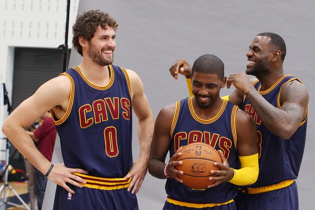 Cleveland Cavaliers' Lebron James, right, Kyrie Irving, center, and Kevin Love joke around during portraits during the NBA team's media day, Monday, Sept. 28, 2015, in Independence, Ohio. (AP Photo/Ron Schwane)