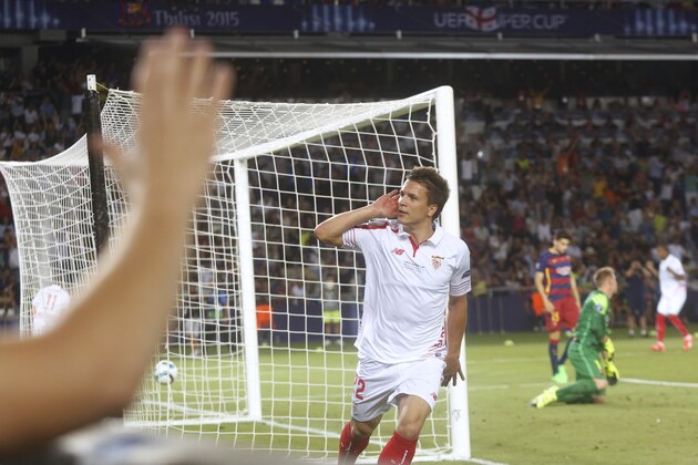Sevilla’s midfielder Yevhen Konoplyanka reacts after scoring against Barcelona during the UEFA Super Cup soccer match between FC Barcelona and Sevilla FC at the Boris Paichadze Dinamo Arena stadium, in Tbilisi, Georgia, on Tuesday, Aug. 11, 2015. Barcelona won 5-4. (AP Photo/Georgy Abdaladze)
