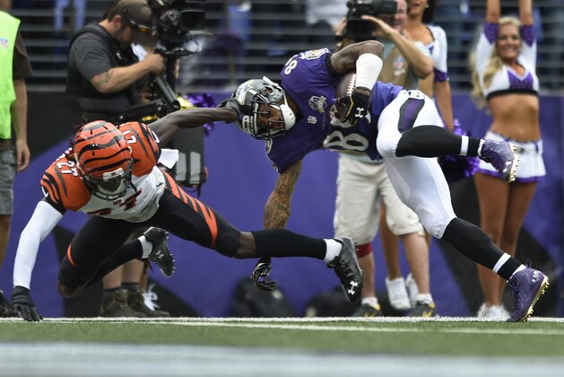 Baltimore Ravens wide receiver Steve Smith (89) leaps over Cincinnati Bengals cornerback Dre Kirkpatrick (27) for a touchdown during the second half of an NFL football game in Baltimore, Sunday, Sept. 27, 2015. (AP Photo/Gail Burton)