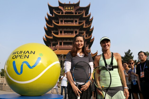 WUHAN, CHINA - SEPTEMBER 28: Former WTA player Li Na (L) of China with Martina Hingis of Switzerland during the Yellow Crane Tower event on Day 2 of 2015 Dongfeng Motor Wuhan Open on September 28, 2015 in Wuhan, China. (Photo by Zhong Zhi/Getty Images)