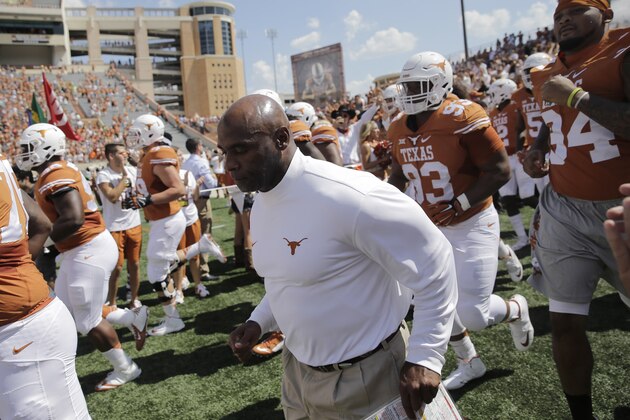 Texas head coach Charlie Strong takes the field with his team before an NCAA college football game against Oklahoma State, Saturday, Sept. 26, 2015, in Austin, Texas. (AP Photo/Eric Gay)