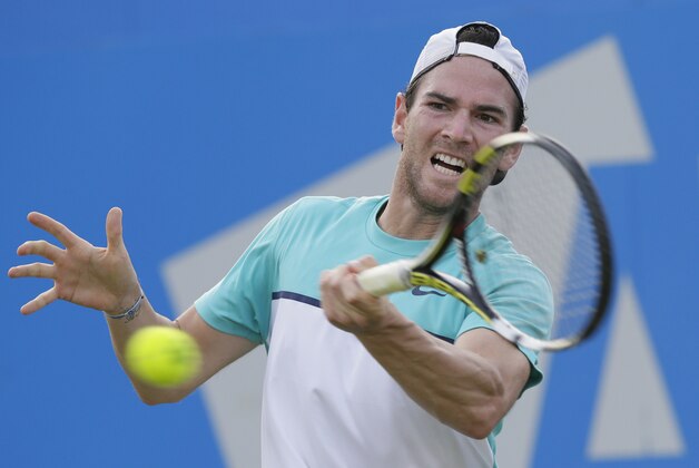 France's Adrian Mannarino returns a ball to Czech Republic's Marin Cilic during their men's singles tennis match at Queen's tennis championship in London, Tuesday June 16, 2015. (AP Photo/Tim Ireland)