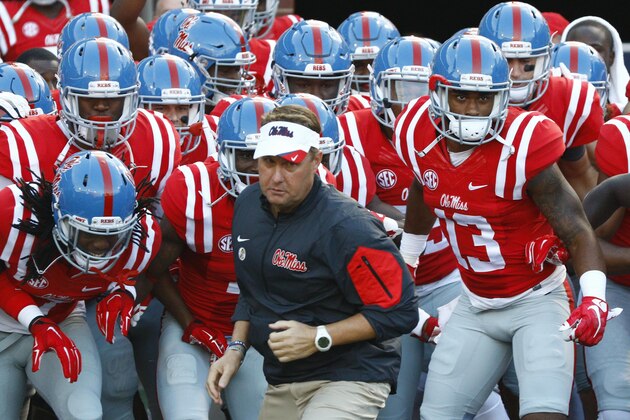 Mississippi football coach Hugh Freeze leads his team on to the field for their NCAA college football game against Vanderbilt in Oxford, Miss., Saturday, Sept. 26, 2015. No. 3 Mississippi won 27-16. (AP Photo/Rogelio V. Solis)