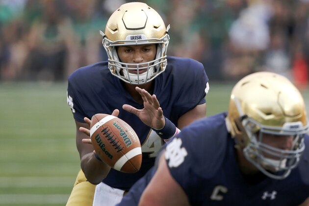 Notre Dame quarterback DeShone Kizer takes the snap in the shotgun formation during the first half of an NCAA college football game against Massachusetts Saturday, Sept. 26, 2015, in South Bend, Ind. (AP Photo/Charles Rex Arbogast)