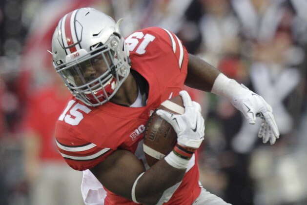 Ohio State running back Ezekiel Elliott escapes the grasp of Western Michigan defensive end Kelon Adams during the fourth quarter of an NCAA college football game, Saturday, Sept. 26, 2015, in Columbus, Ohio. Ohio State defeated Western Michigan 38-12. (AP Photo/Jay LaPrete)