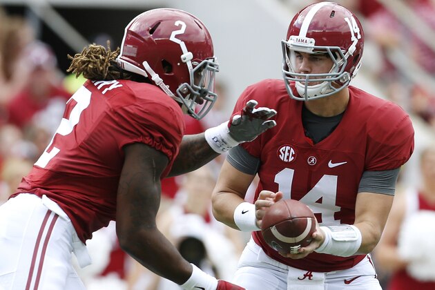 Alabama quarterback Jake Coker (14) hands the ball to running back Derrick Henry (2) during the first half of an NCAA college football game against Louisiana Monroe in Tuscaloosa, Ala., Saturday, Sept. 26, 2015. (AP Photo/Jonathan Bachman)