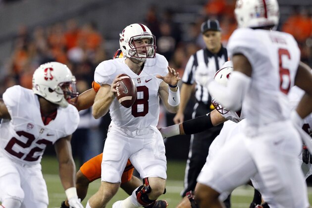 Stanford quarterback Kevin Hogan, center, looks for a receiver during the first half of an NCAA college football game against Oregon State in Corvallis, Ore., Friday, Sept. 25, 2015. (AP Photo/Timothy J. Gonzalez)