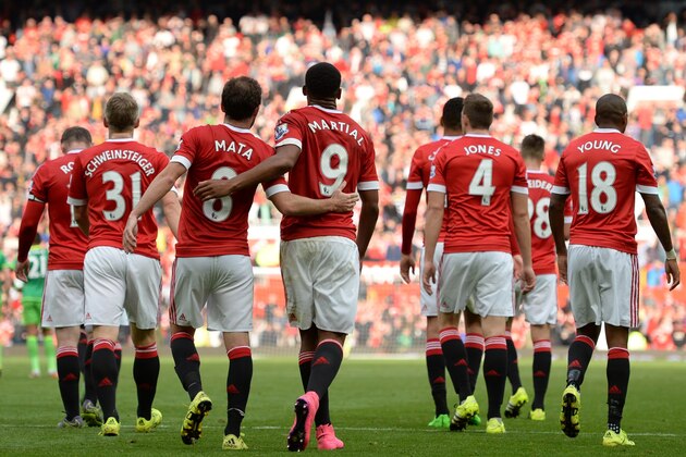 United players walk back to the half way line, after scoring their third goal during the English Premier League football match between Manchester United and Sunderland at Old Trafford in Manchester, north west England, on September 26, 2015. Manchester United won the game 3-0. AFP PHOTO / OLI SCARFF

RESTRICTED TO EDITORIAL USE. No use with unauthorized audio, video, data, fixture lists, club/league logos or 'live' services. Online in-match use limited to 75 images, no video emulation. No use in betting, games or single club/league/player publications.        (Photo credit should read OLI SCARFF/AFP/Getty Images)