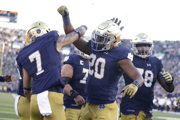 Notre Dame running back C.J. Prosise (20), right,  celebrates a touchdown wide receiver Will Fuller (7) during the second half of an NCAA college football game against Georgia Tech in South Bend, Ind., Saturday, Sept. 19, 2015. Notre Dame defeated Georgia Tech  30-22. (AP Photo/Michael Conroy)