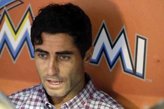 A.J. Preller, general manager of the San Diego Padres talks with reporters in the dugout before a baseball game against the Miami Marlins, Friday, July 31, 2015, in Miami. (AP Photo/Lynne Sladky)