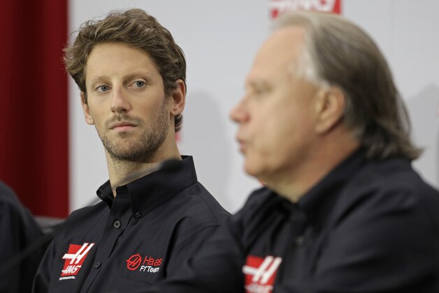 Driver Romain Grosjean, left, listens as team owner Gene Haas, right, answers a question during a news conference for Haas Racing's Formula One auto race team in Kannapolis, N.C., Tuesday, Sept. 29, 2015. (AP Photo/Chuck Burton)