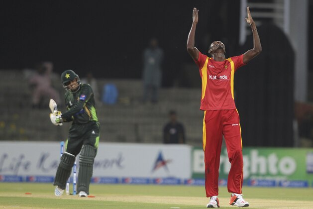 Zimbabwe pacer Christopher Mpofu, right, celebrates after taking wicket of Pakistan's Baber Azam, left, during third one-day international match between Pakistan and Zimbabwe at Gaddafi Stadium in Lahore, Pakistan, Sunday, May 31, 2015. (AP Photo/Anjum Naveed)