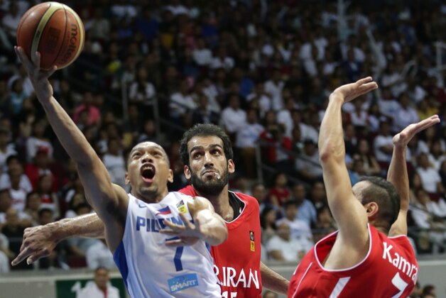 The Philippines' Jayson William, left,  scores over Iran's Hamed Hadadi, center, Mahdi Kamrany, right,  during the final game in the 27th FIBA Asia Basketball Championship at the Mall of Asia Arena at suburban Pasay city, south of Manila, Philippines, Sunday, Aug. 11, 2013. Iran won 85-71 to grab the gold.  (AP Photo/Bullit Marquez)