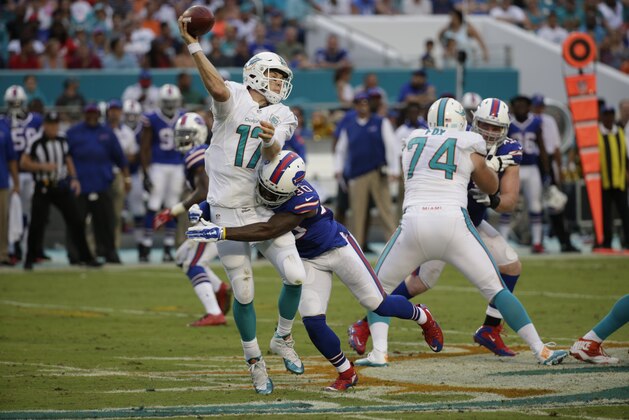 Buffalo Bills strong safety Bacarri Rambo (30) tackles Miami Dolphins quarterback Ryan Tannehill (17) during the first half of an NFL football game, Sunday, Sept. 27, 2015 in Miami Gardens, Fla. (AP Photo/Wilfredo Lee)