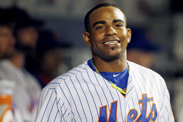 New York Mets Yoenis Cespedes smiles in the dugout after hitTing a third-inning, solo, home run in a baseball game against the Miami Marlins in New York, Monday, Sept. 14, 2015. (AP Photo/Kathy Willens)