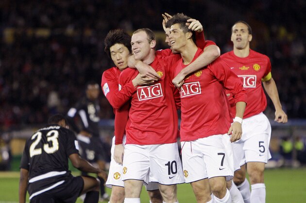 Wayne Rooney, third from right, smiles as he is hugged by his teammates, Cristiano Ronaldo, second from right, Park Ji-sung, fourth from right, as Jairo Campos (23) of Ecuador's Liga Deportiva Universitaria Quito reacts after Rooney scored a goal during their final match at the FIFA Club World Cup soccer tournament in Yokohama, Japan, Sunday, Dec. 21, 2008. Manchester United won the final 1-0. Running at right is  Rio Ferdinand (5) of Manchester United. (AP Photo/David Guttenfelder)