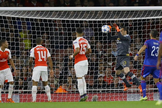 Arsenal goalkeeper David Ospina, second right, drops the ball into his own net to concede a goal during the Champions League Group F soccer match between Arsenal and Olympiakos at Emirates stadium in London Tuesday, Sept. 29, 2015. (AP Photo/Kirsty Wigglesworth)
