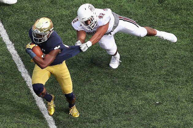 SOUTH BEND, IN - SEPTEMBER 26: C.J. Prosise #20 of the Notre Dame Fighting Irish breaks away from John Robinson-Woodgett #42 of the Massachusetts Minutemen at Notre Dame Stadium on September 26, 2015 in South Bend, Indiana. (Photo by Jonathan Daniel/Getty Images)