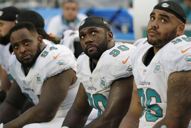 Miami Dolphins defensive tackles C.J. Mosley (94), Earl Mitchell (90) and A.J. Francis (96) look  up during the second half of an NFL football game against the Buffalo Bills in Miami Gardens, Fla. The Bills defeated the Dolphins 41-14.  With high hopes and a favorable early schedule, the  Dolphins expected to get off to a fast start. Instead they're last in the AFC East, and coach Joe Philbin's job security has never looked shakier.(AP Photo/Wilfredo Lee)