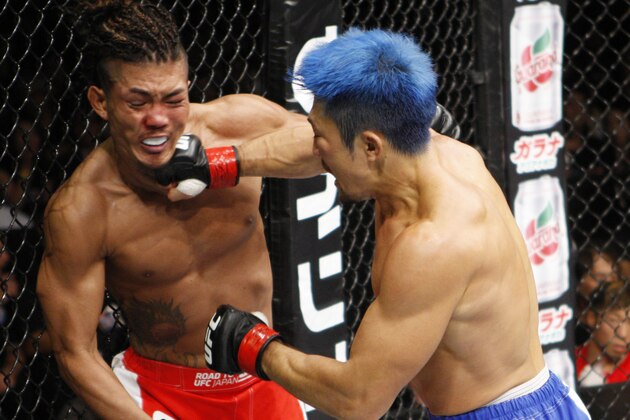 SAITAMA, JAPAN - SEPTEMBER 27: (From L to R) Teruto Ishihara of Japan and Mizuto Hirota of Japan exchange punches in their featherweight bout during the UFC event at the Saitama Super Arena on September 27, 2015 in Saitama, Japan. (Photo by Mitch Viquez/Zuffa LLC/Zuffa LLC via Getty Images)