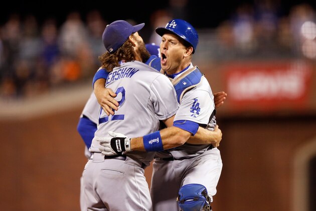 SAN FRANCISCO, CA - SEPTEMBER 29:  Clayton Kershaw #22 and A.J. Ellis #17 of the Los Angeles Dodgersn celebrate after they beat the San Francisco Giants to clinch the National League West title at AT&T Park on September 29, 2015 in San Francisco, California.  (Photo by Ezra Shaw/Getty Images)