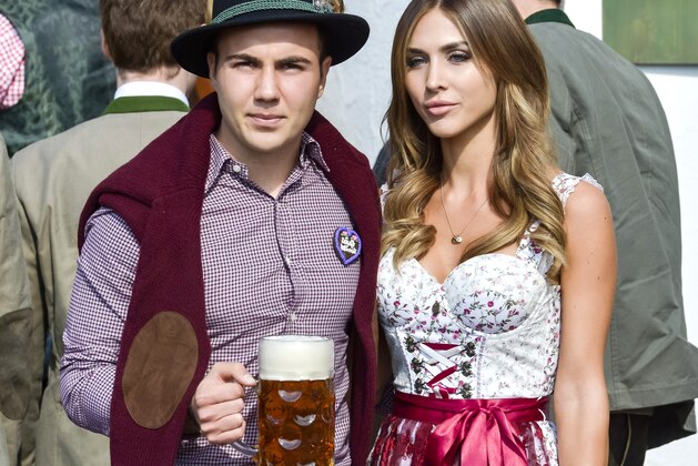 Bayern Munich's German midfielder Mario Goetze and his girlfriend Ann Kathrine Broemmel dressed in traditional Bavarian clothing visit the Oktoberfest venue in Munich, southern Germany, on September 30, 2015. AFP PHOTO / GUENTER SCHIFFMANN        (Photo credit should read GUENTER SCHIFFMANN/AFP/Getty Images)
