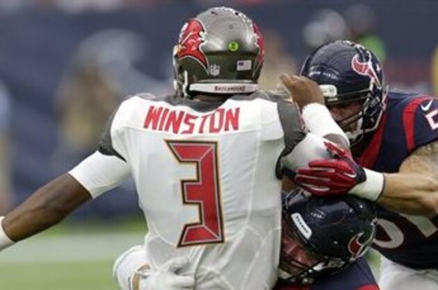 Tampa Bay Buccaneers' Jameis Winston (3) is hit by Houston Texans' Jared Crick (93) and John Simon (51) during the first half of an NFL football game Sunday, Sept. 27, 2015, in Houston. (AP Photo/David J. Phillip)