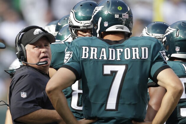 Philadelphia Eagles head coach Chip Kelly talks with Philadelphia Eagles quarterback Sam Bradford (7) during a time out against the New York Jets during the fourth quarter of an NFL football game, Sunday, Sept. 27, 2015, in East Rutherford, N.J. (AP Photo/Adam Hunger)